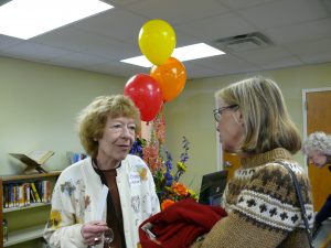 Woman having a conversation in front of balloons