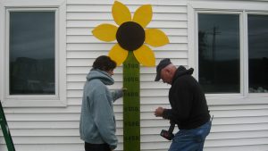 Fundraising sign with flower on top