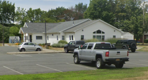 Photo of library building and parking lot.
